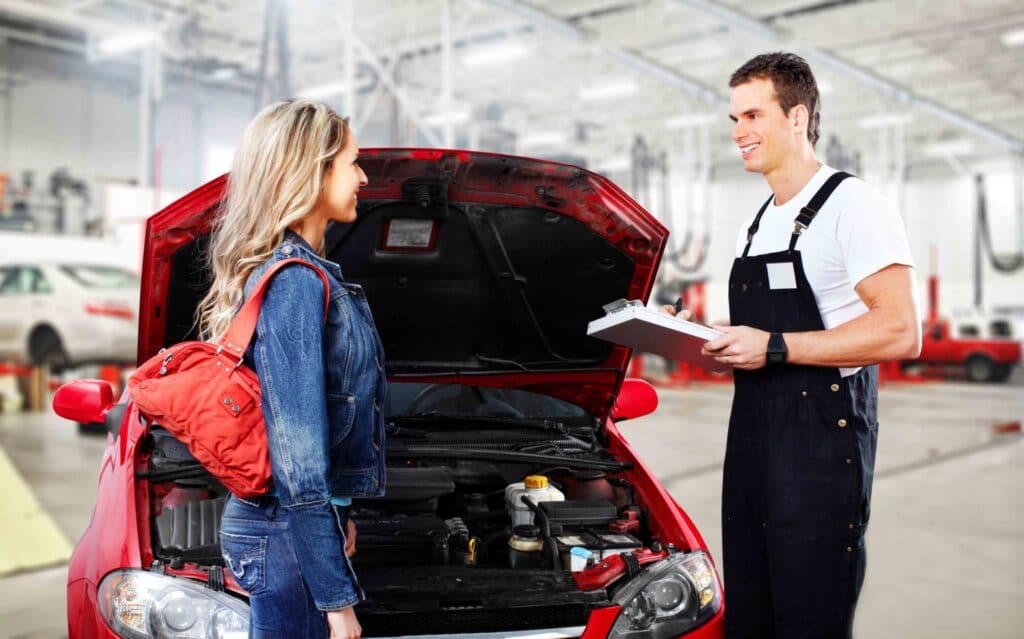 auto repair technician speaks to customer