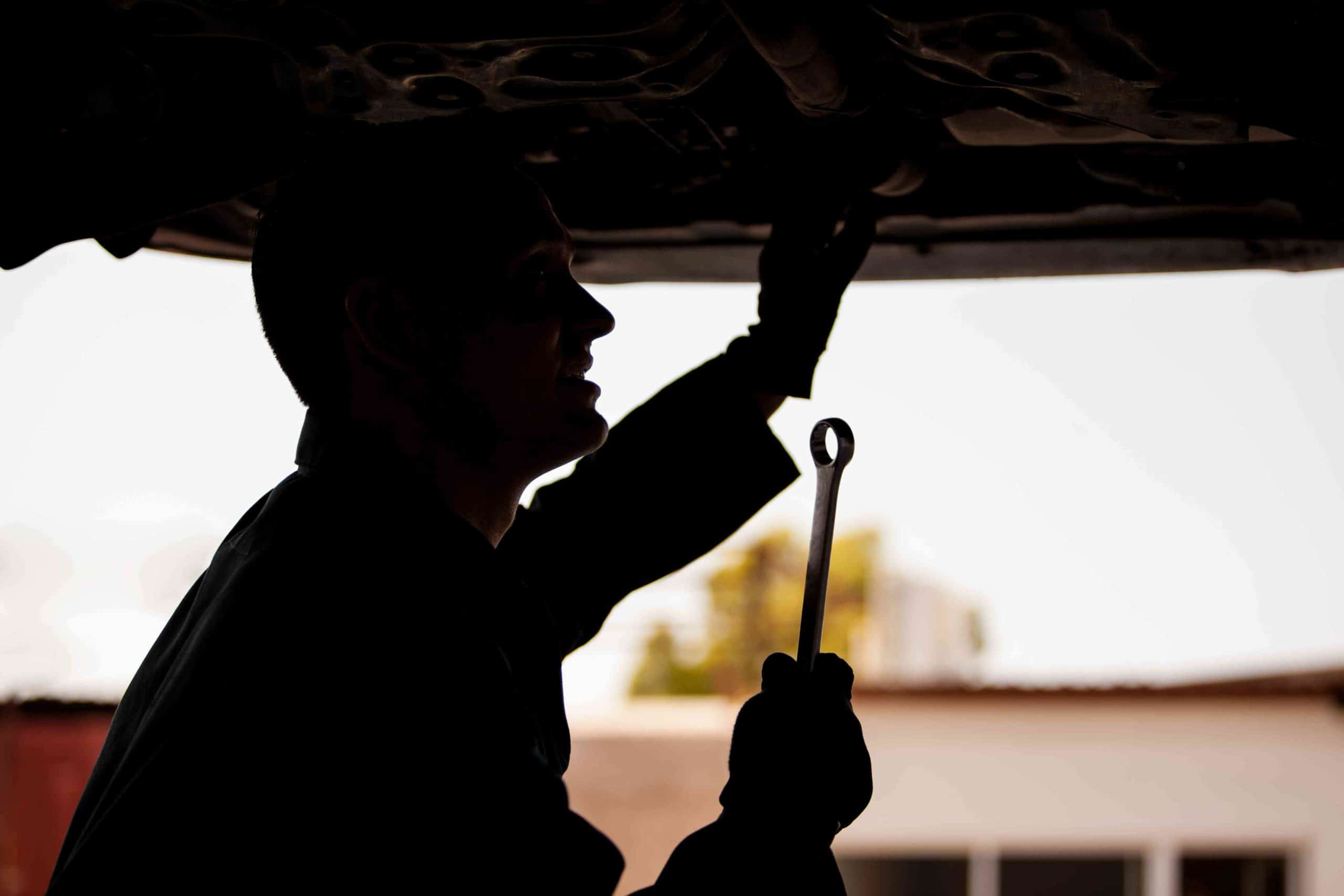 auto repair technician working on a car